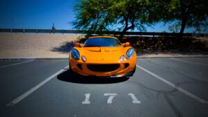 a yellow sports car parked in a parking lot